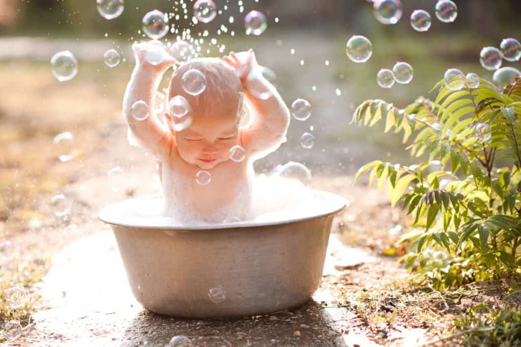 toddler child playing in a tub