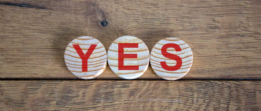 Wooden alphabet blocks spelling the word "YES"