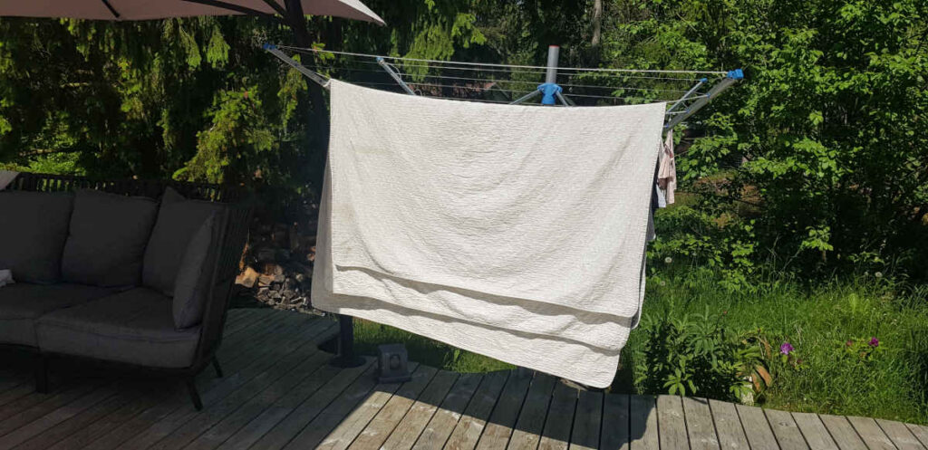 blanket or curtain fabric hung out to dry in a backyard