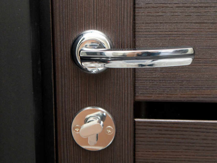 closeup of door knob on wooden brown door
