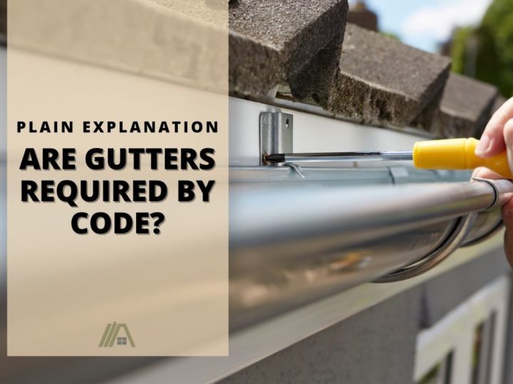 Hand holding a yellow handled screwdriver installing a gutter; Are Gutters Required By Code? (Plain English Explanation)