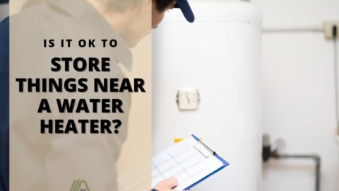 Man holding a checklist inspecting a water heater; Is It OK to store things near a water heater?