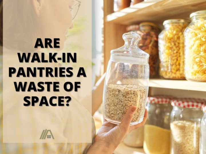 Woman holding a jar of food taken from a pantry shelf; Are Walk-in Pantries a Waste of Space? (Pros and cons table included)
