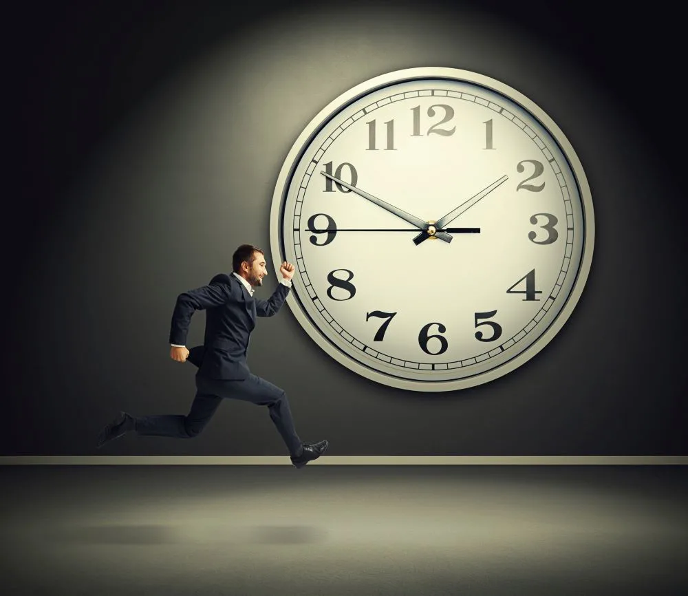 man in suit running for something towards the right direction; huge analog clock