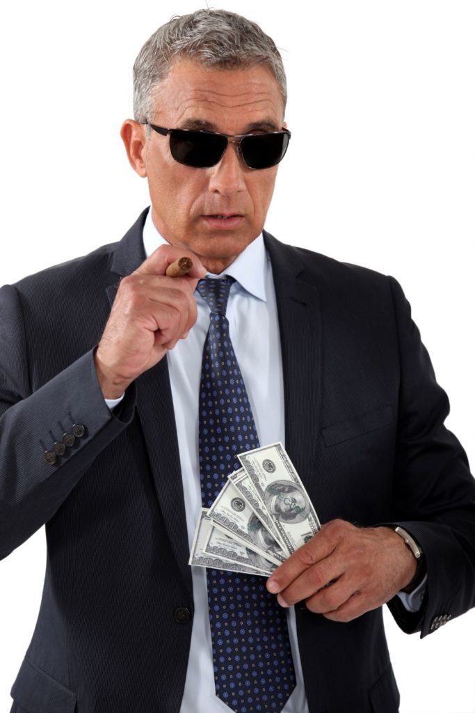 Businessman with cigar and money