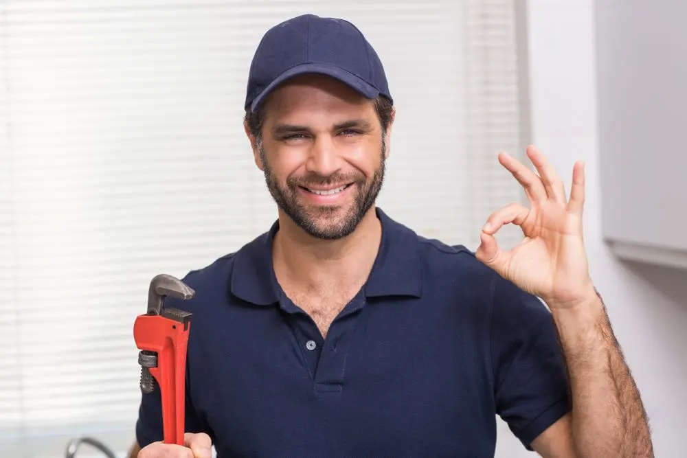 Casual plumber smiling at camera