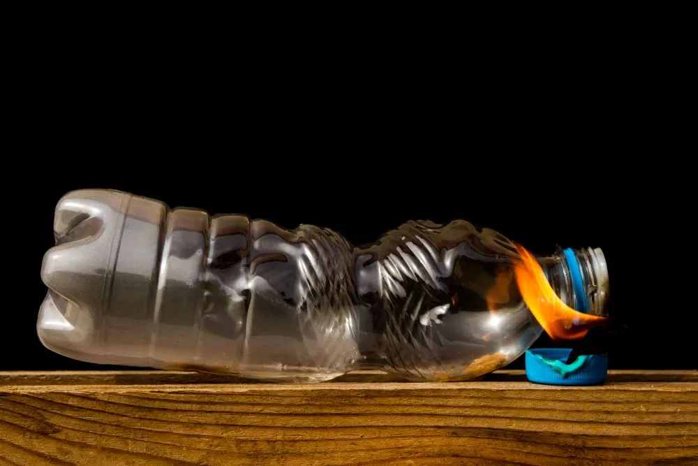 Close up of a plastic bottle slowly burning
