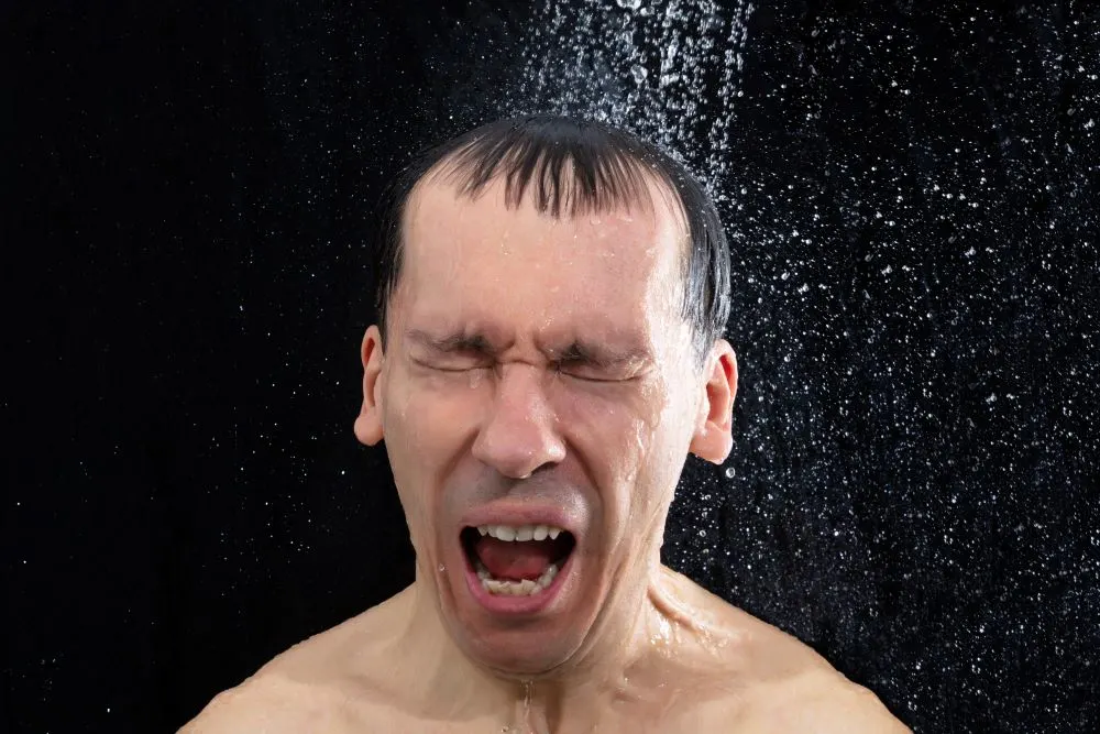 Portrait Of Young Man Taking Cold Shower In Bathroom