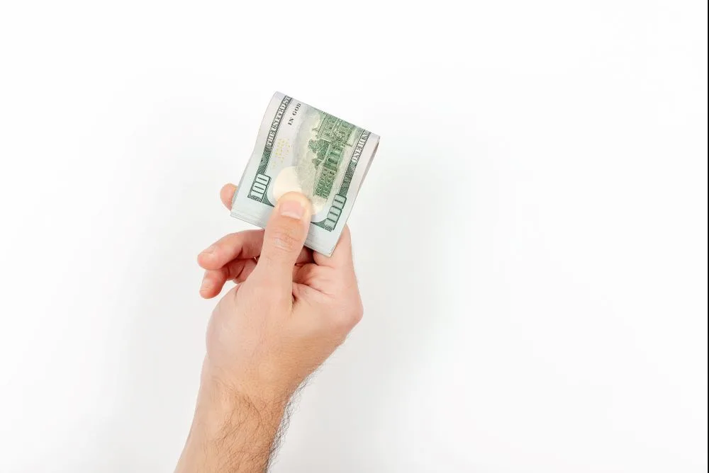Unrecognizable mature man holding US Dollar bills