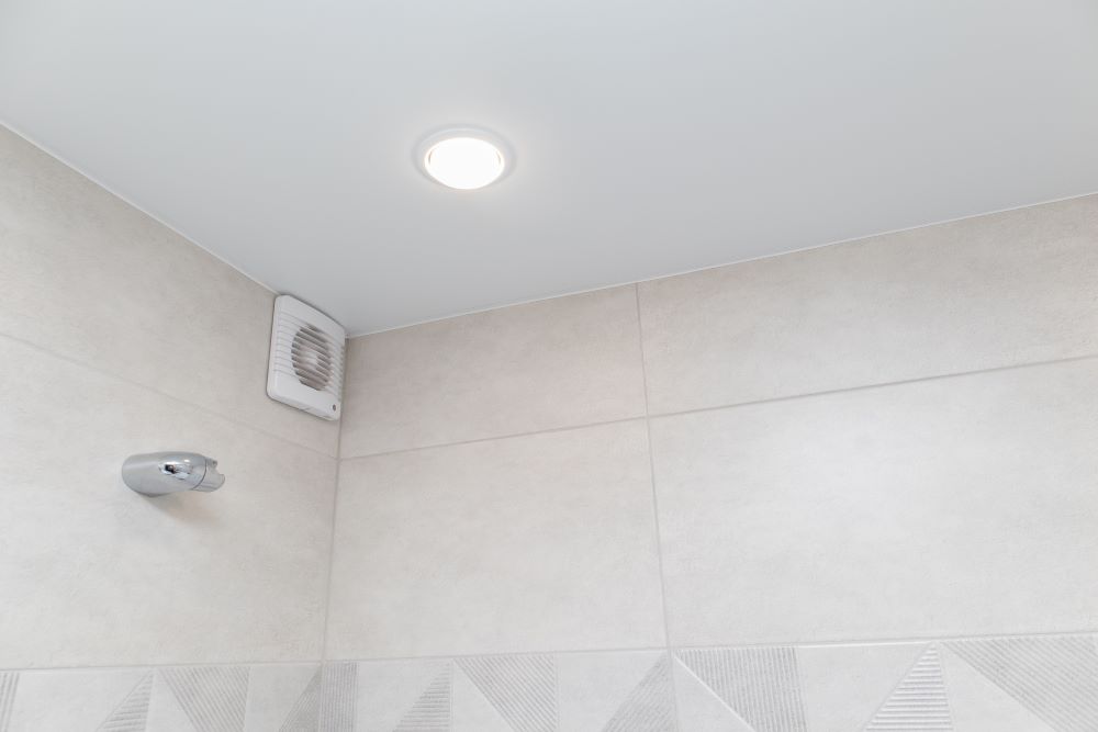 Bathroom exhaust fan installed close to the ceiling
