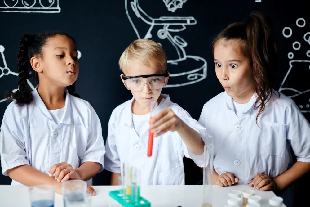 Group of kids and teachers carrying out a science