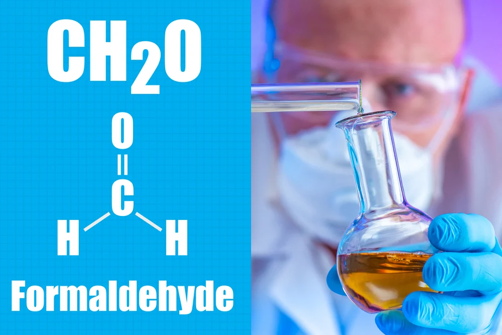 Formaldehyde. Formula CH2O. Man mixes the reagents. Laboratory assistant face and test tubes close-up. Organic Compound Formaldehyde. Manufacture of rubber formaldehyde. Rubber Product Manufacturing