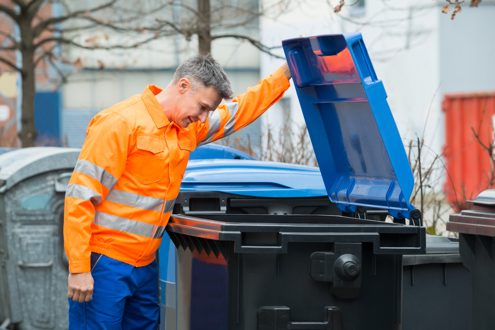 Working Man Looking In Dustbin On Street cleaning garbage cans