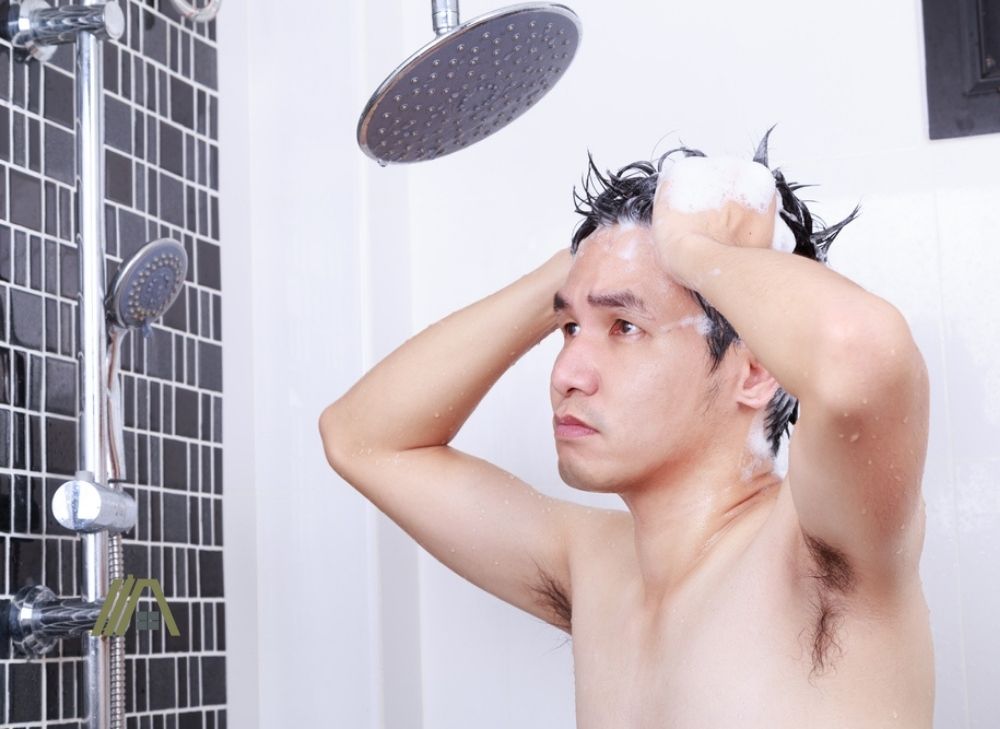 man taking a shower. man thinking of problem