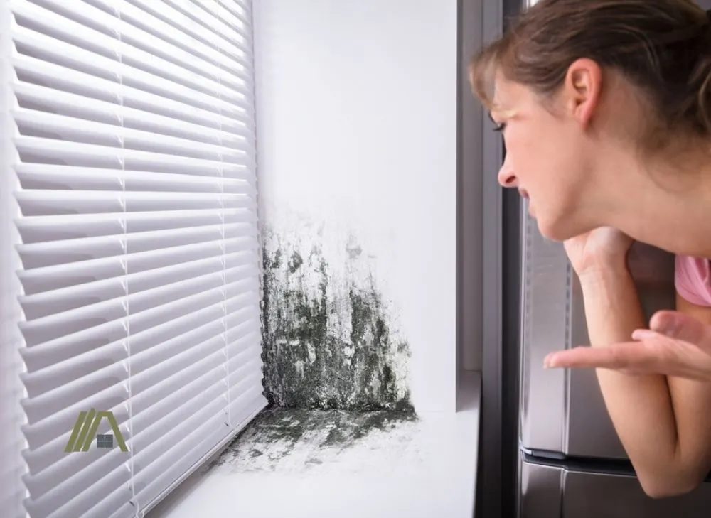 woman looking and pointing on mold