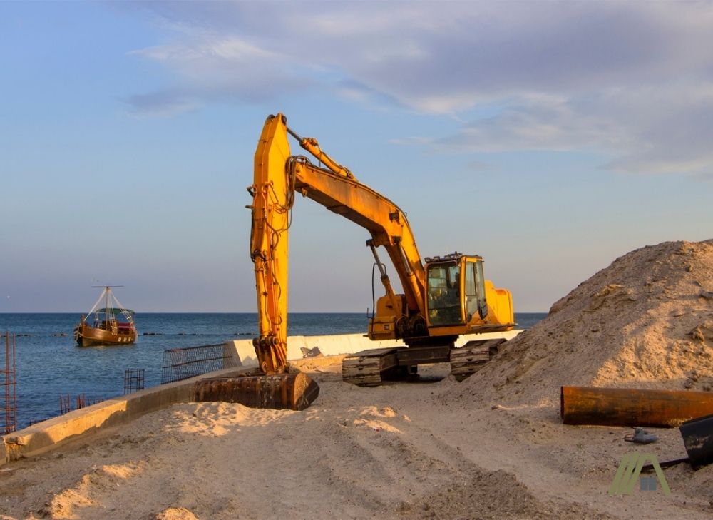 Excavating sandy soil in coastal area