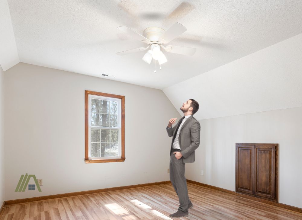 Man standing below the ceiling fan