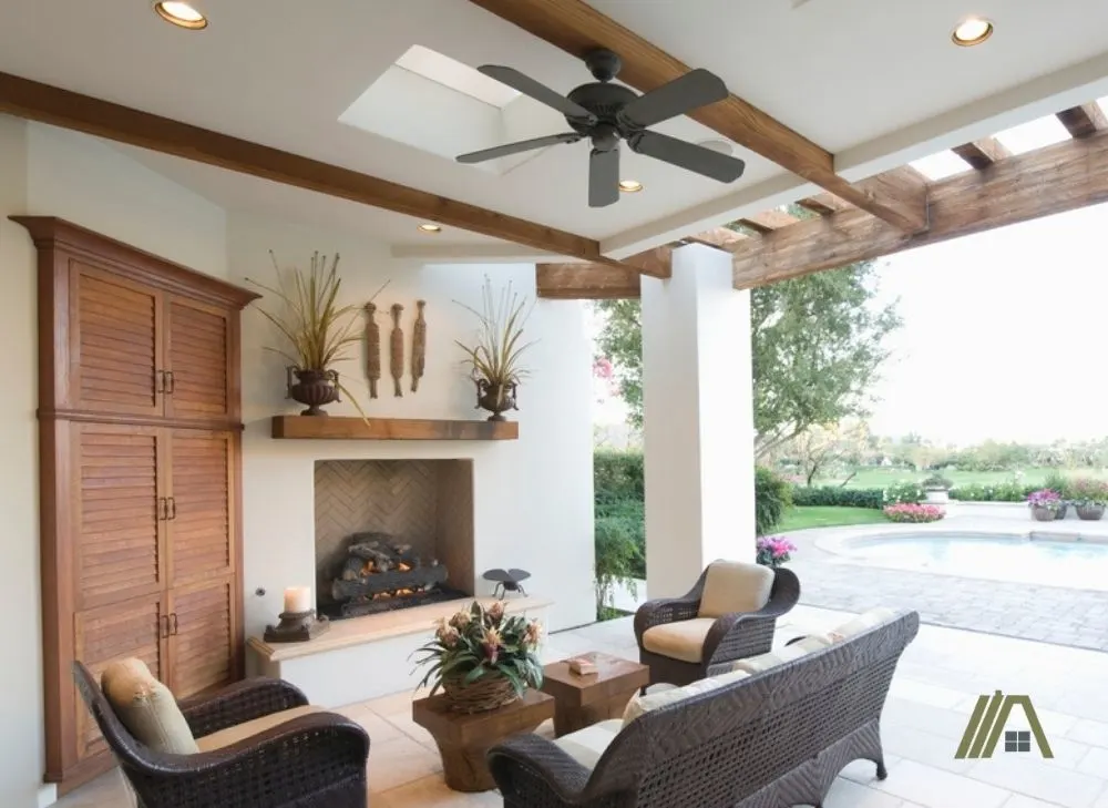 outdoor ceiling fan covered backyard with pool and fire place