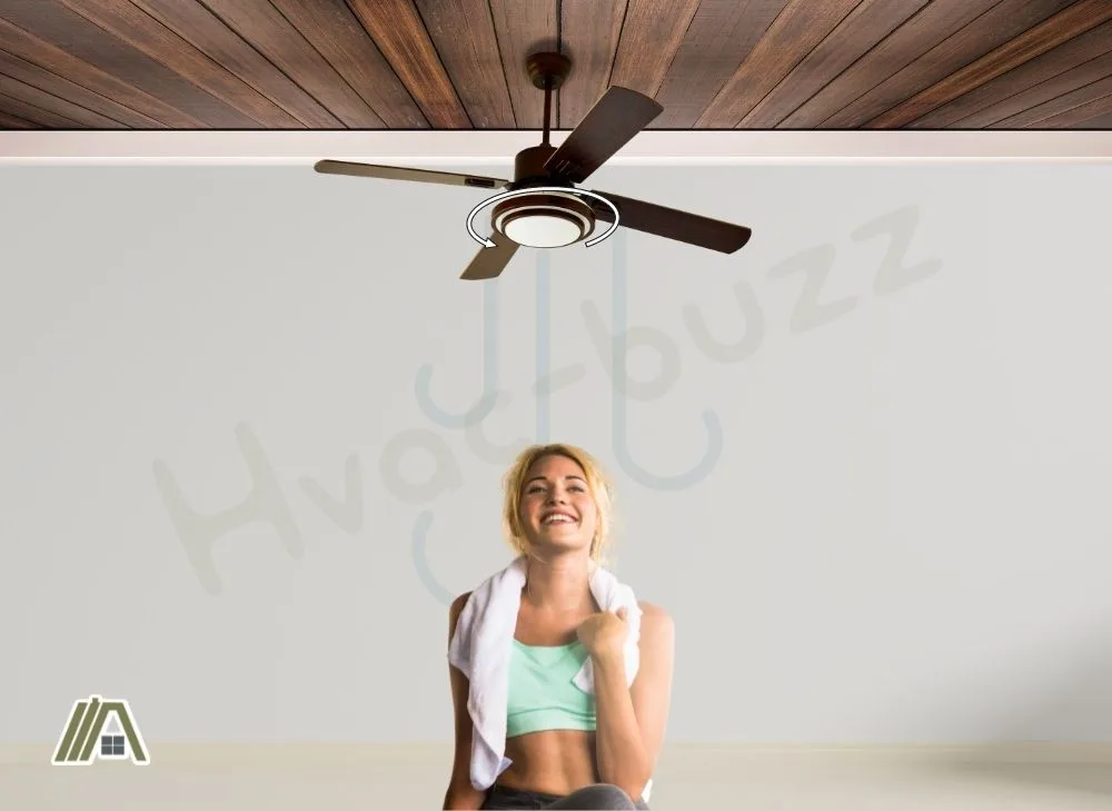 Sweaty woman under a ceiling fan made of wood