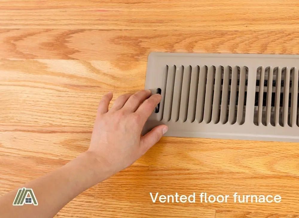 Hand opening the vented floor furnace