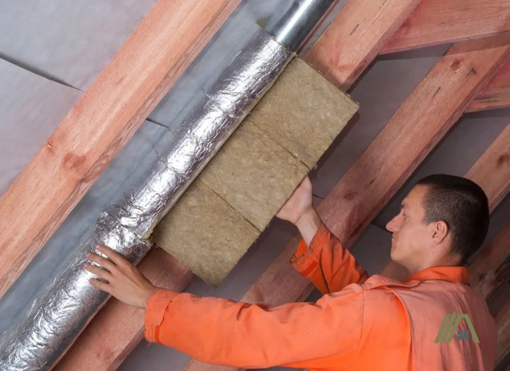Man-putting-an-insulation-to-an-installed-duct