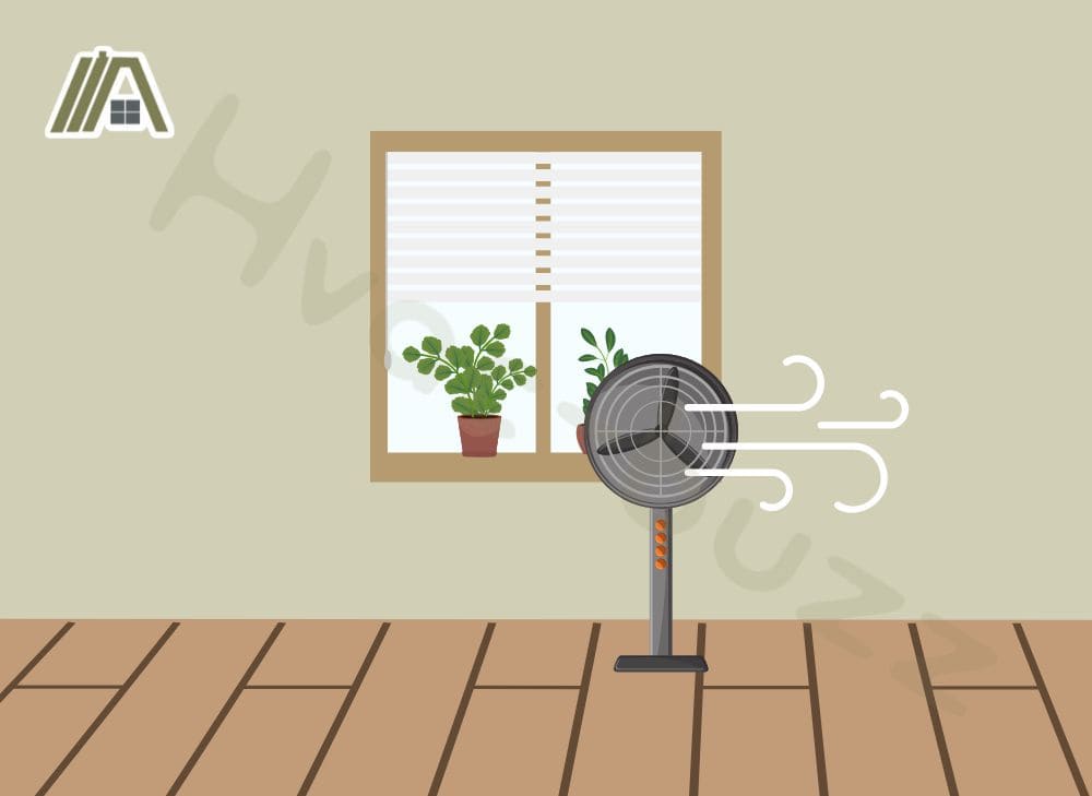 Illustration of a black stand fan placed in front of an open window