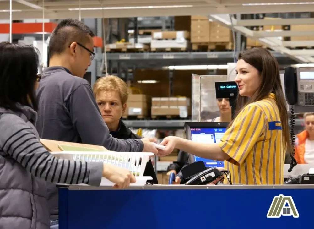 Cashier in IKEA giving the customer's receipt