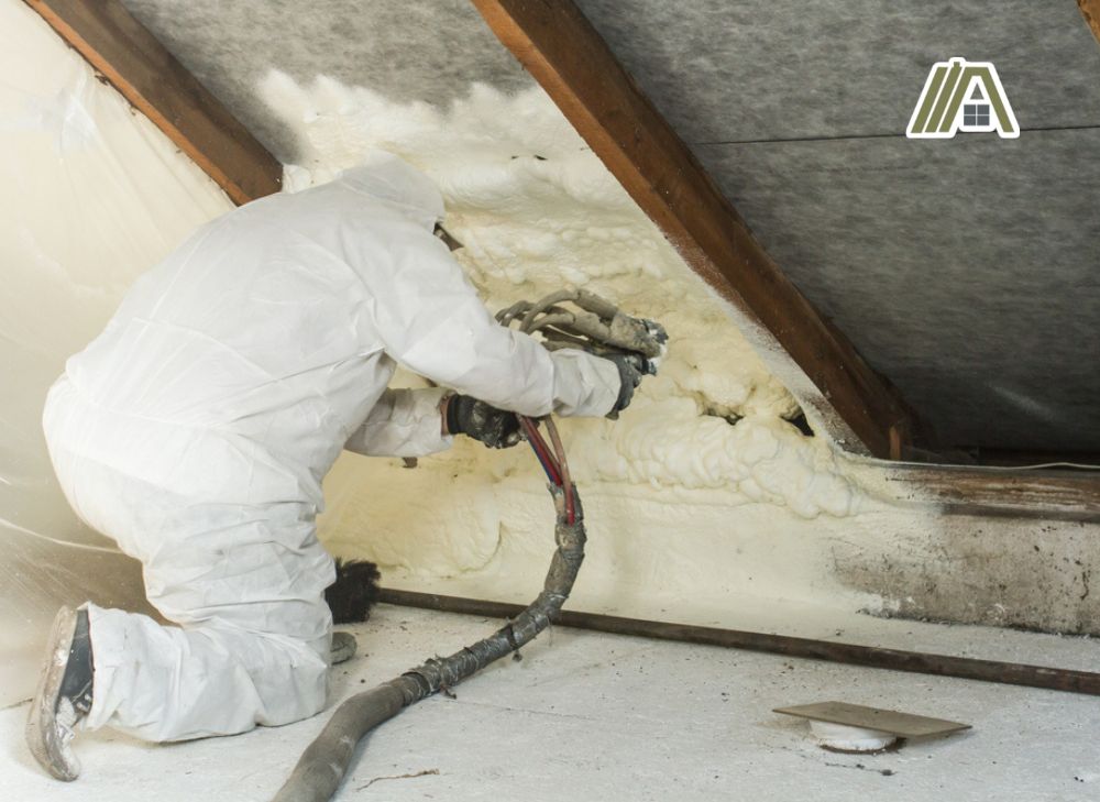 Man-in-PPE-spraying-foam-insulation-on-roof-frame
