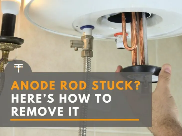 man removing anode rod and heating element from water heater
