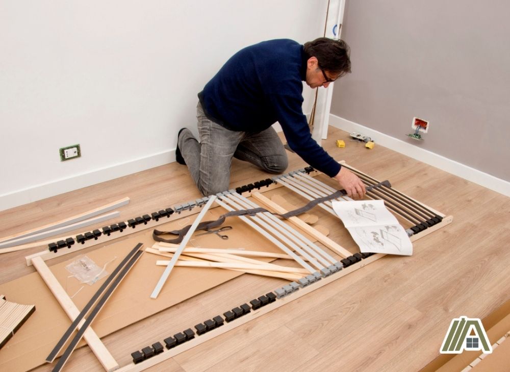 Man assembling a bed frame from IKEA