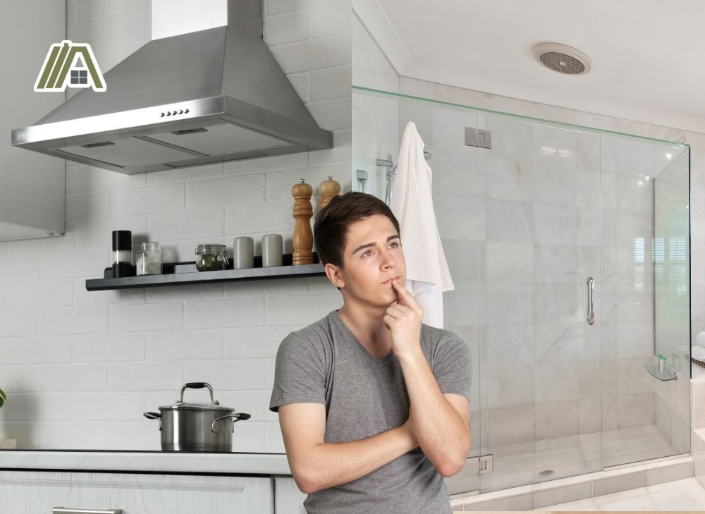 Man thinking about the range hood and exhaust inside the bathroom