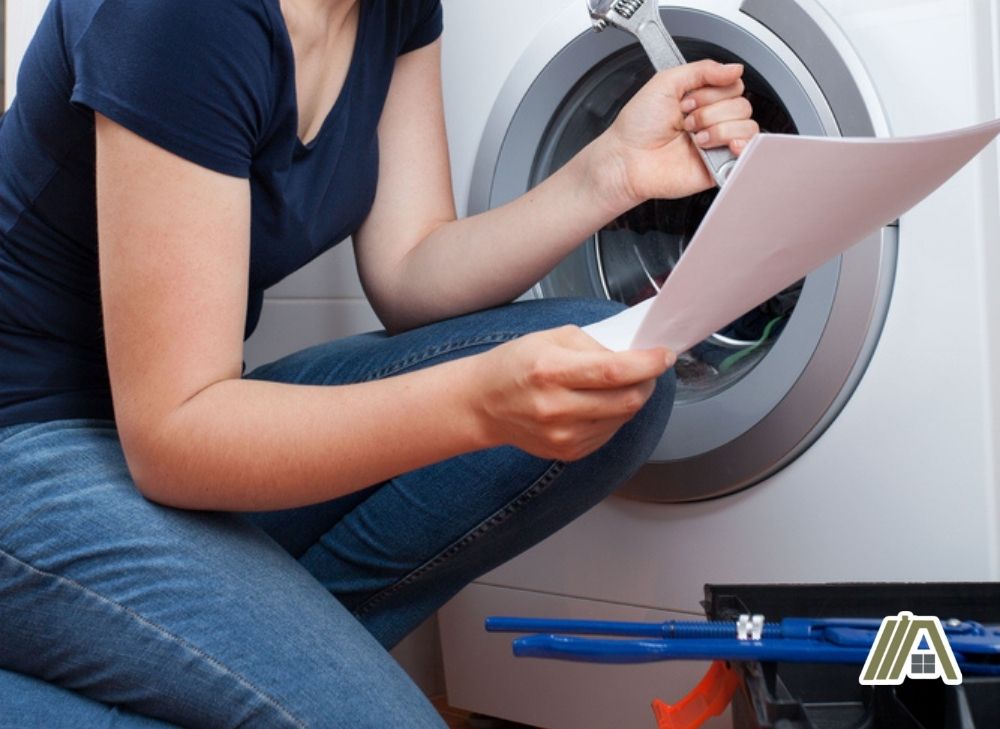 Woman reading a manual for a washer