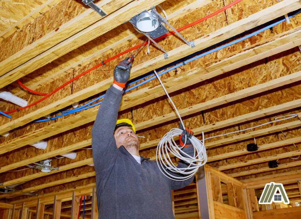 Man checking wiring on the ceiling.jpg