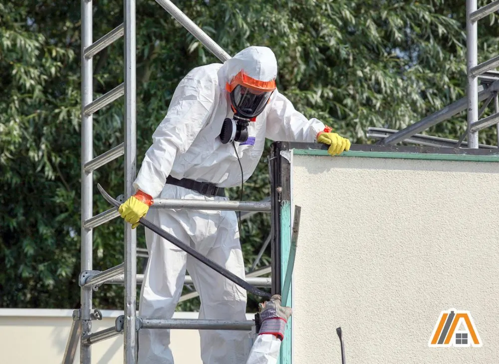 Man wearing PPE about to remove asbestos