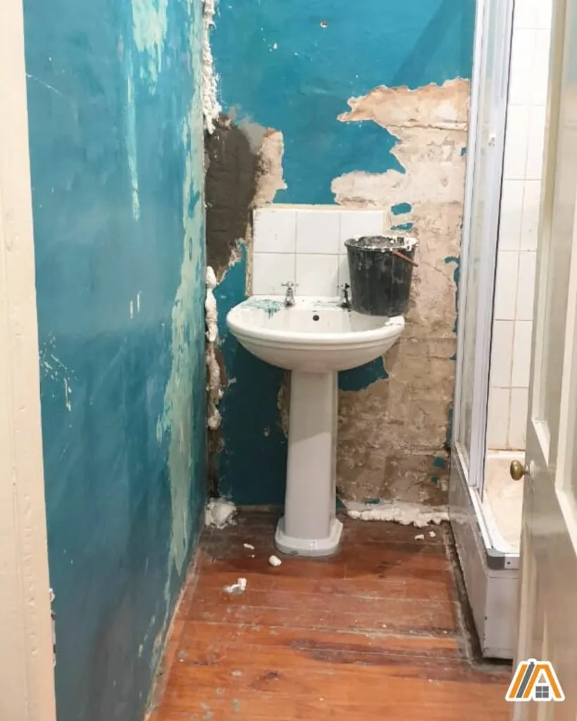 Bathroom wall in the process of removing turquoise paint