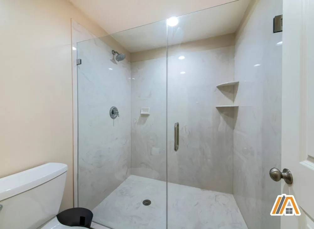 Bathroom with frameless shower and marble walls