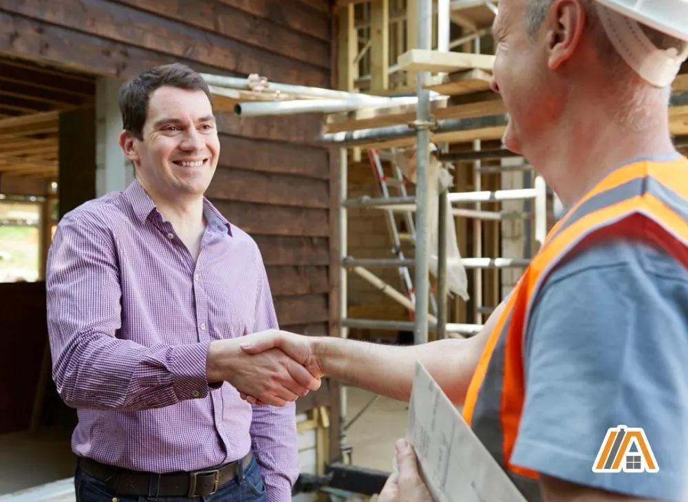 Man shaking his hand with a builder.jpg