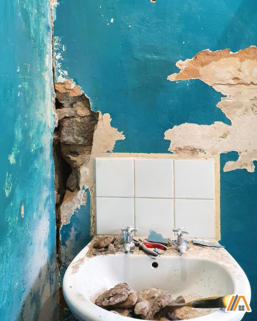 Renovating an old bathroom with turquoise walls, damaged bathroom wall