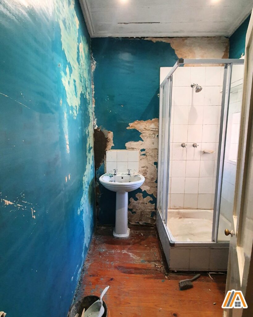 Renovating an old bathroom with turquoise walls, sink and shower cubicle