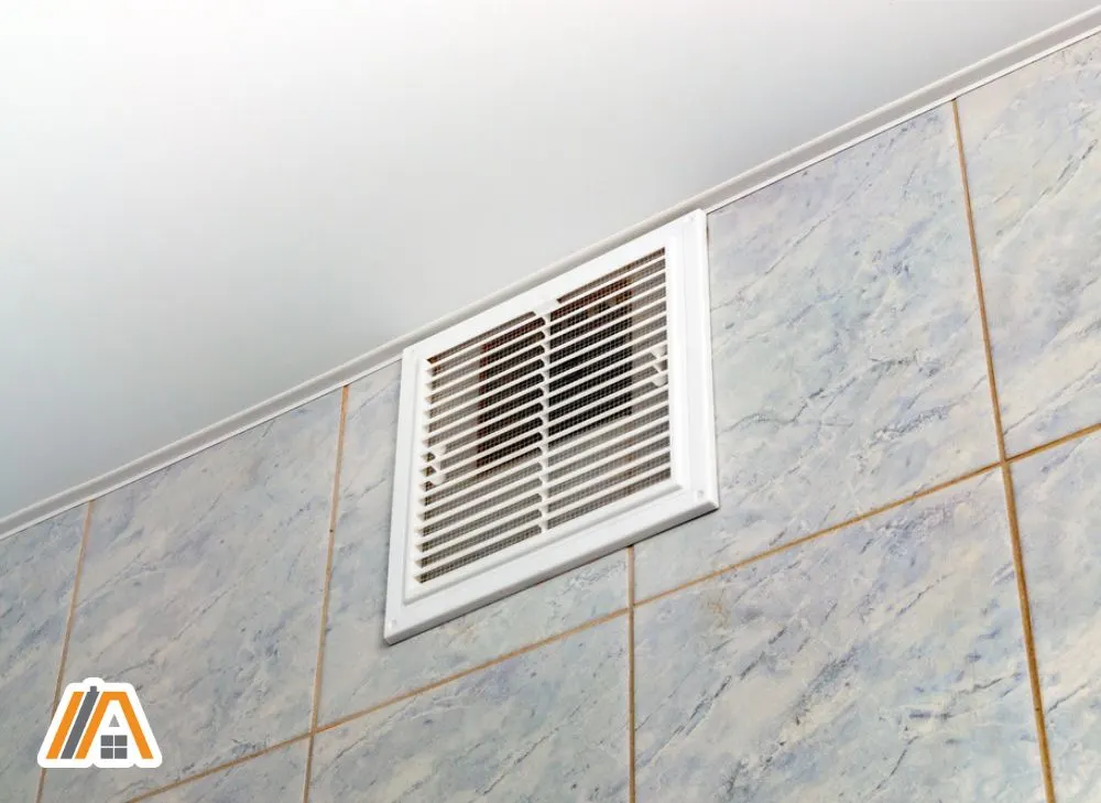 Bathroom exhaust fan on the wall with marble tiles