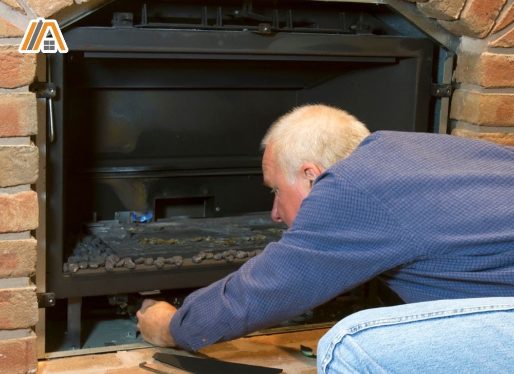 Man fixing a gas fireplace