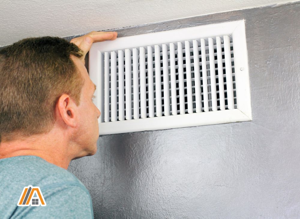 Man inspecting a home air vent.jpg