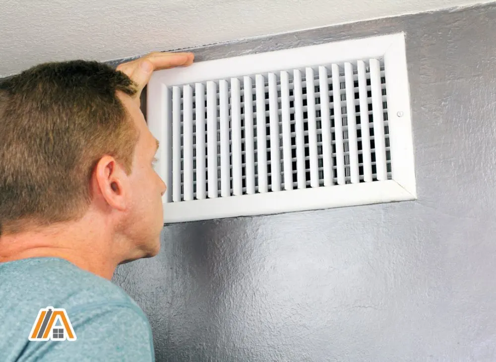 Man inspecting a home air vent.jpg