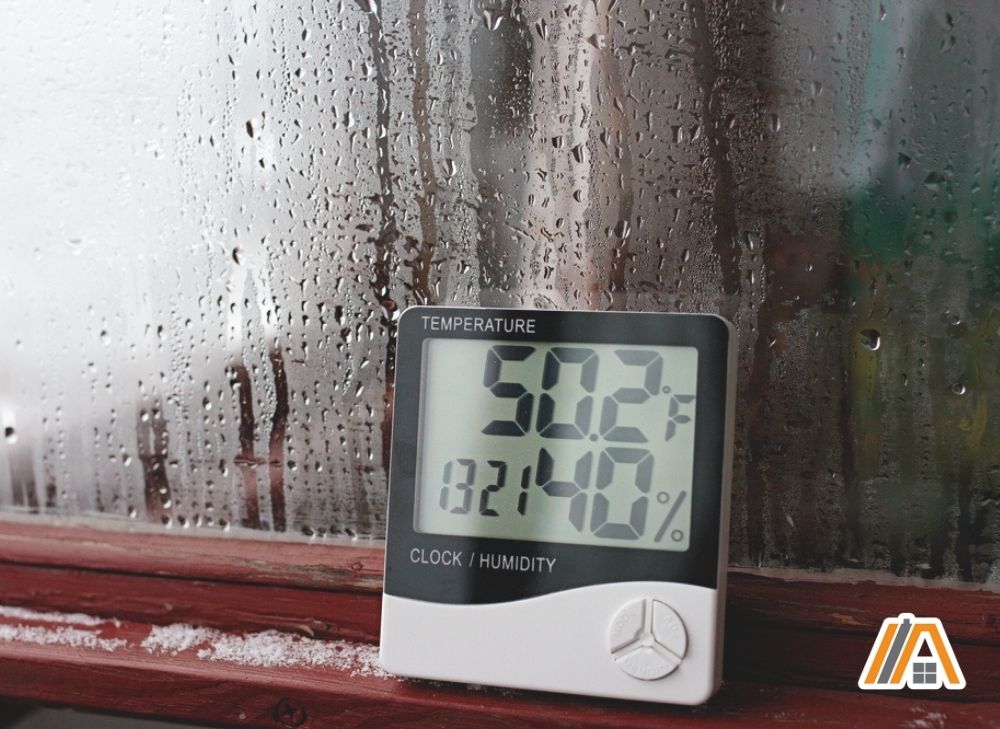 Humidity sensor and a thermometer placed on a moist window