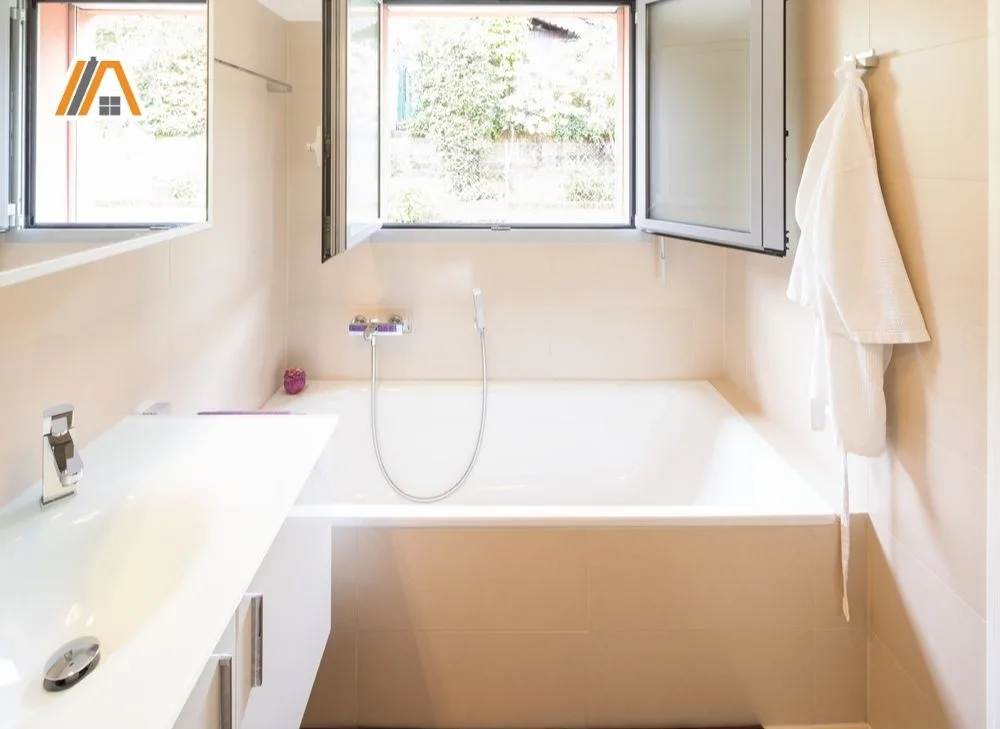 Modern white bathroom with square bath tub and an open window.jpg