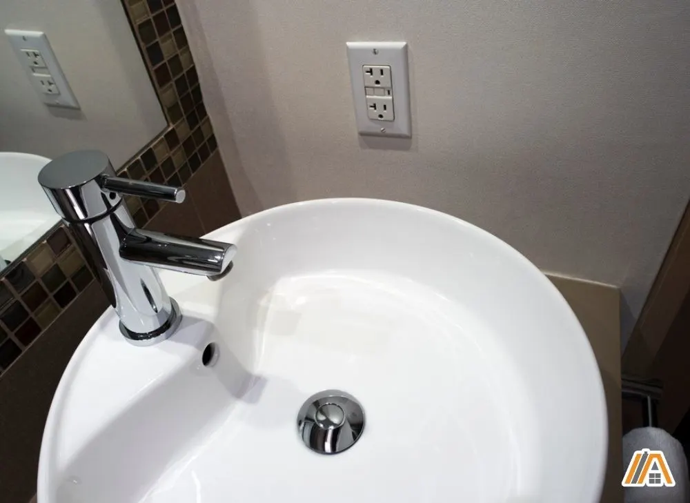 Round wash basin with a GFCI outlet on the side.jpg