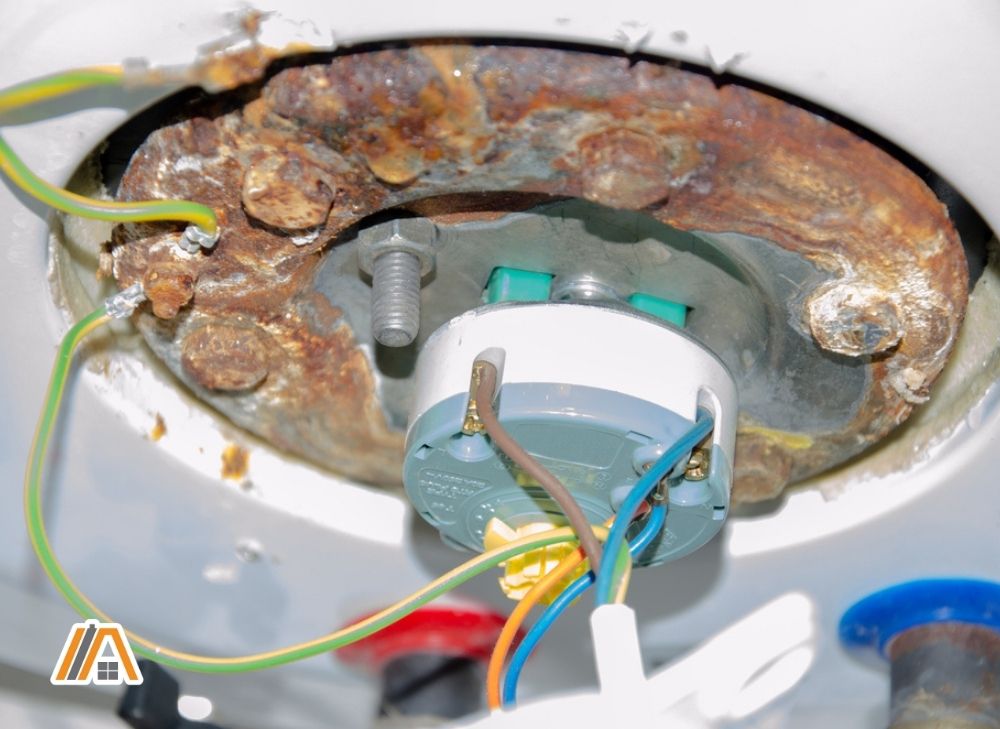 Rust at the bottom of the water heater and exposed wiring.jpg