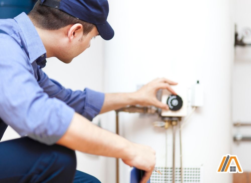 Technician-checking-the-thermostat-of-a-water-heater